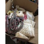 A box of misc items to include 2 christening gowns, curtains ties, crochetware, etc. Catalogue only,