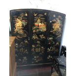 A black laquered and chinoiserie decorated triple wardrobe with fitted interior drawers Catalogue