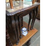 A glass and leather top reproduction nestnof tables Catalogue only, live bidding available via our