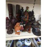 A collection of ethnic wooden carved figures and masks, together with 3 resin figures if Chinese