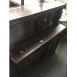 An Ercol court cupboard Catalogue only, live bidding available via our website. If you require P&P