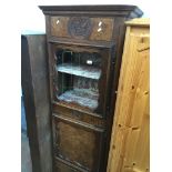 A tall narrow continental style oak cabinet Catalogue only, live bidding available via our