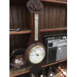 A carved oak cased aneroid barometer - J.J. Lockwood, Preston Catalogue only, live bidding available