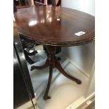 An oval mahogany side table Catalogue only, live bidding available via our website. If you require