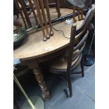 An oak round dining table with four ladder back and rush seated chairs Catalogue only, live