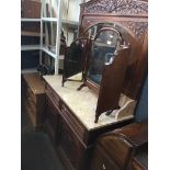 A Continental carved oak mirror back wash stand with carved floral details and beadwork decoration