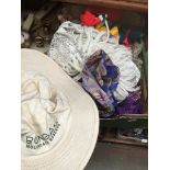 A box with various silk scarves and a hat Catalogue only, live bidding available via our website.