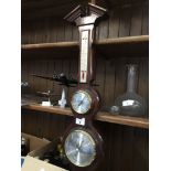 A wall hanging barometer with thermometer and hygrometer Catalogue only, live bidding available