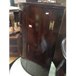 George III bow front mahogany corner cupboard Catalogue only, live bidding available via our