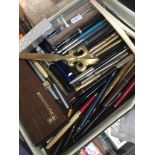 A box of propelling pencils and pens Catalogue only, live bidding available via our website.