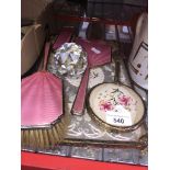 A 3 piece pink enamel dressing set ( 2 brushes and mirror ) and 2 trays and embroidered mirror.