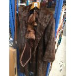 A fur coat and a fox fur stole. Catalogue only, live bidding available via our website. Please