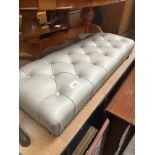 A studded and cream leather long foot stool Catalogue only, live bidding available via our