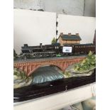 A model of a steam train on plinth Catalogue only, live bidding available via our website. Please