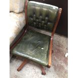Green leather button back swivel chair Catalogue only, live bidding available via our website.