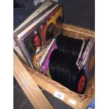 A wicker basket complete with 45's and LP's Catalogue only, live bidding available via our