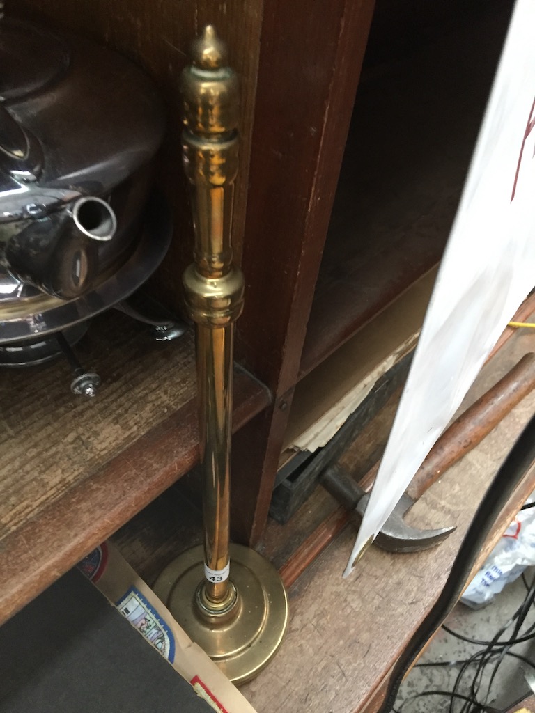 A brass poker in a stand Catalogue only, live bidding available via our website. Please note we