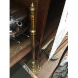 A brass poker in a stand Catalogue only, live bidding available via our website. Please note we