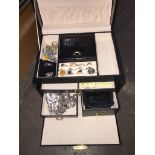 A Black jewellery box complete with contents Catalogue only, live bidding available via our website.