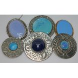 A group of six white metal brooches including Arts & Crafts target brooches, Celtic style etc.