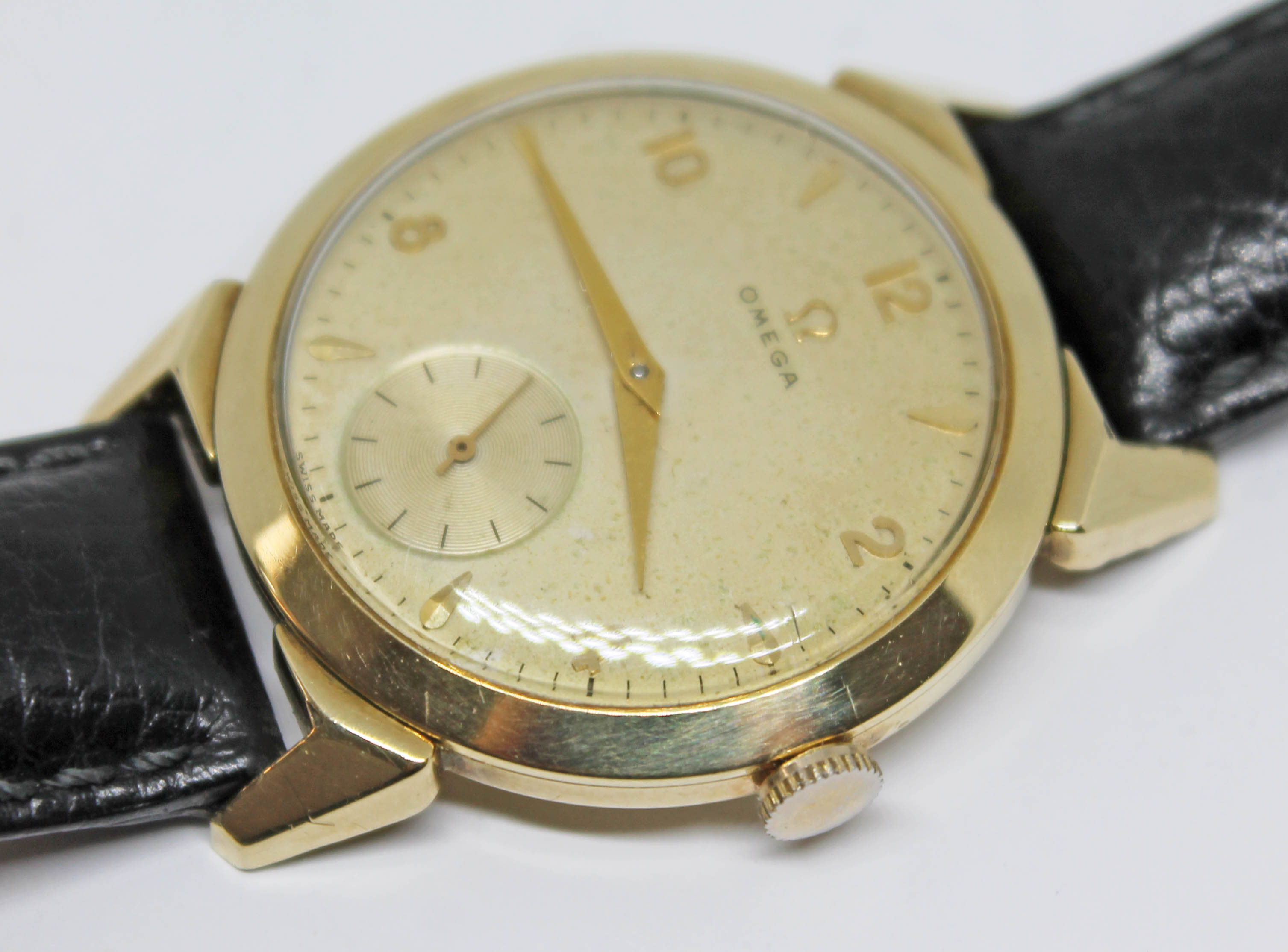 A 1952 gold plated Omega wristwatch with gold tone signed dial, alternate Roman numerals and hour