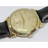 A 1952 gold plated Omega wristwatch with gold tone signed dial, alternate Roman numerals and hour