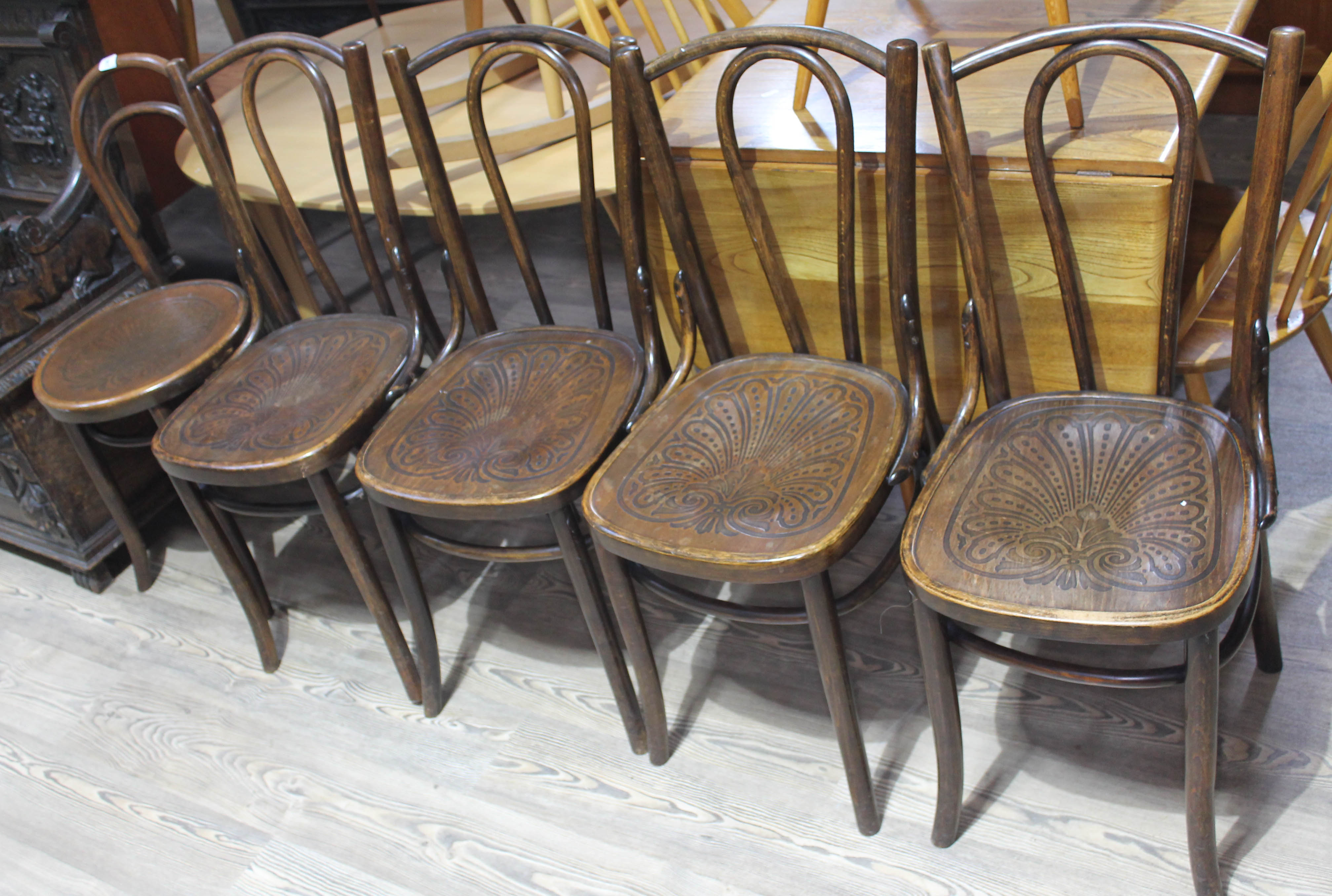 A group of five bentwood cafe style chairs. Condition: each with split to back panel and a couple