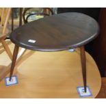 A dark elm Ercol single pebble table, height 40cm, width 66cm. Condition: no signs of any damage,