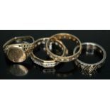A group of four rings comprising two hallmarked 9ct gold and two eternity rings marked '9ct',
