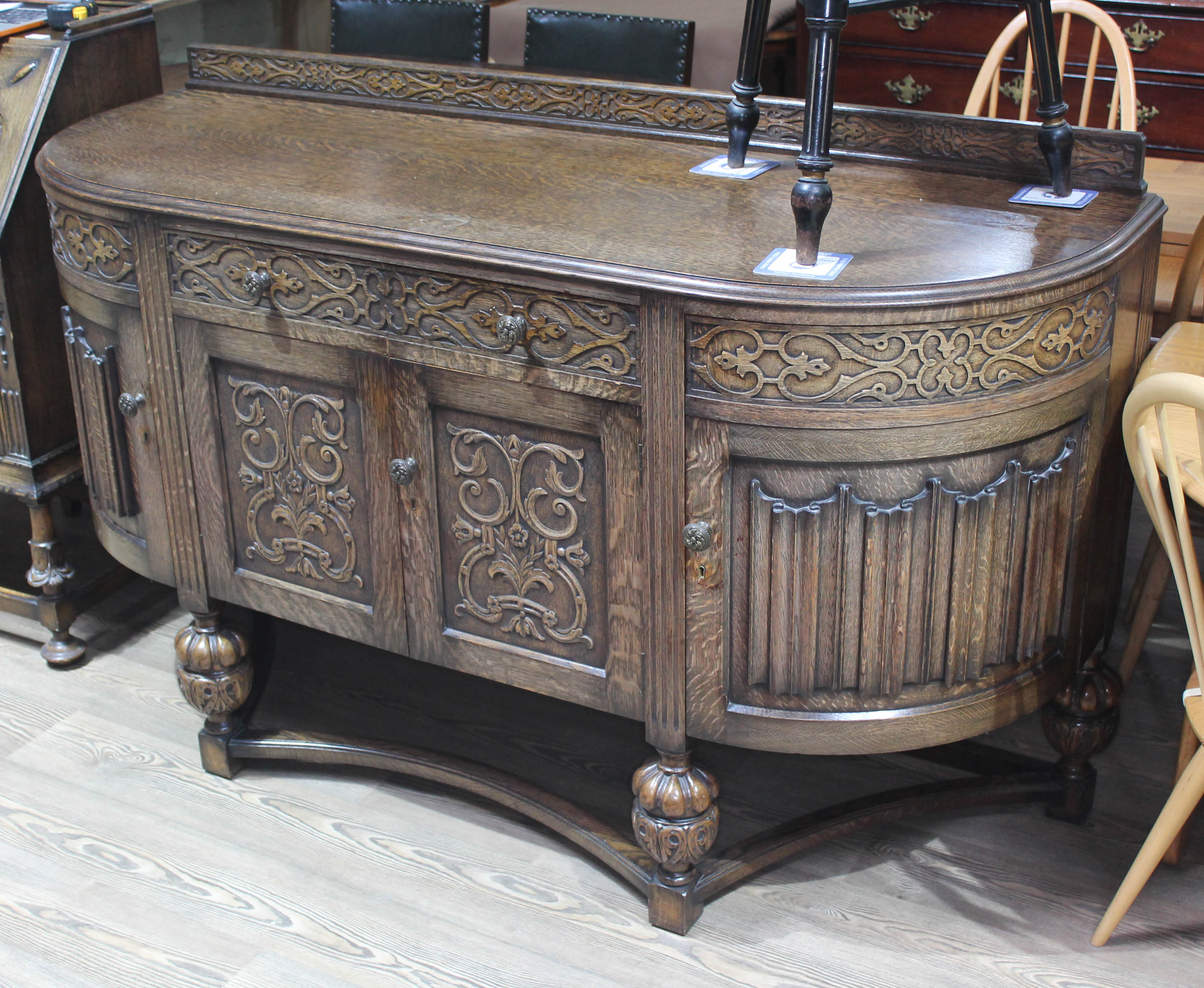 A 1930s Jacobean style carved oak sideboard, length 165cm, depth 59cm & height 101cm. Condition: