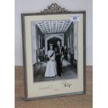 Elizabeth II and Prince Philip signed presentation photograph, dated 1983,glazed with white metal