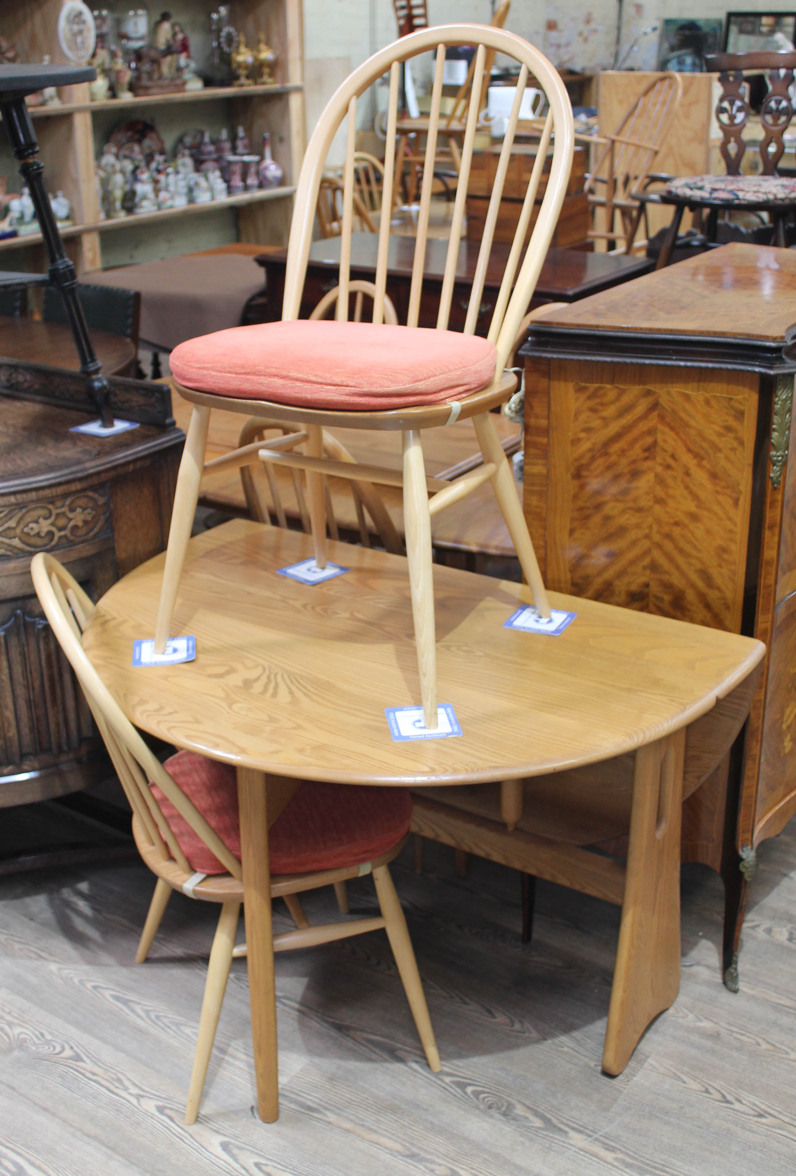 An Ercol blonde drop leaf table and two chairs. Condition - good, no dame/repairs, minor wear only