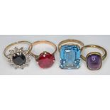 A group of four rings comprising a hallmarked 9ct gold sapphire and diamond cluster ring, a