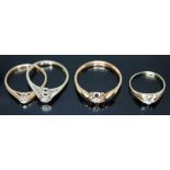 A group of four rings comprising two hallmarked 9ct gold diamond solitaires, another diamond