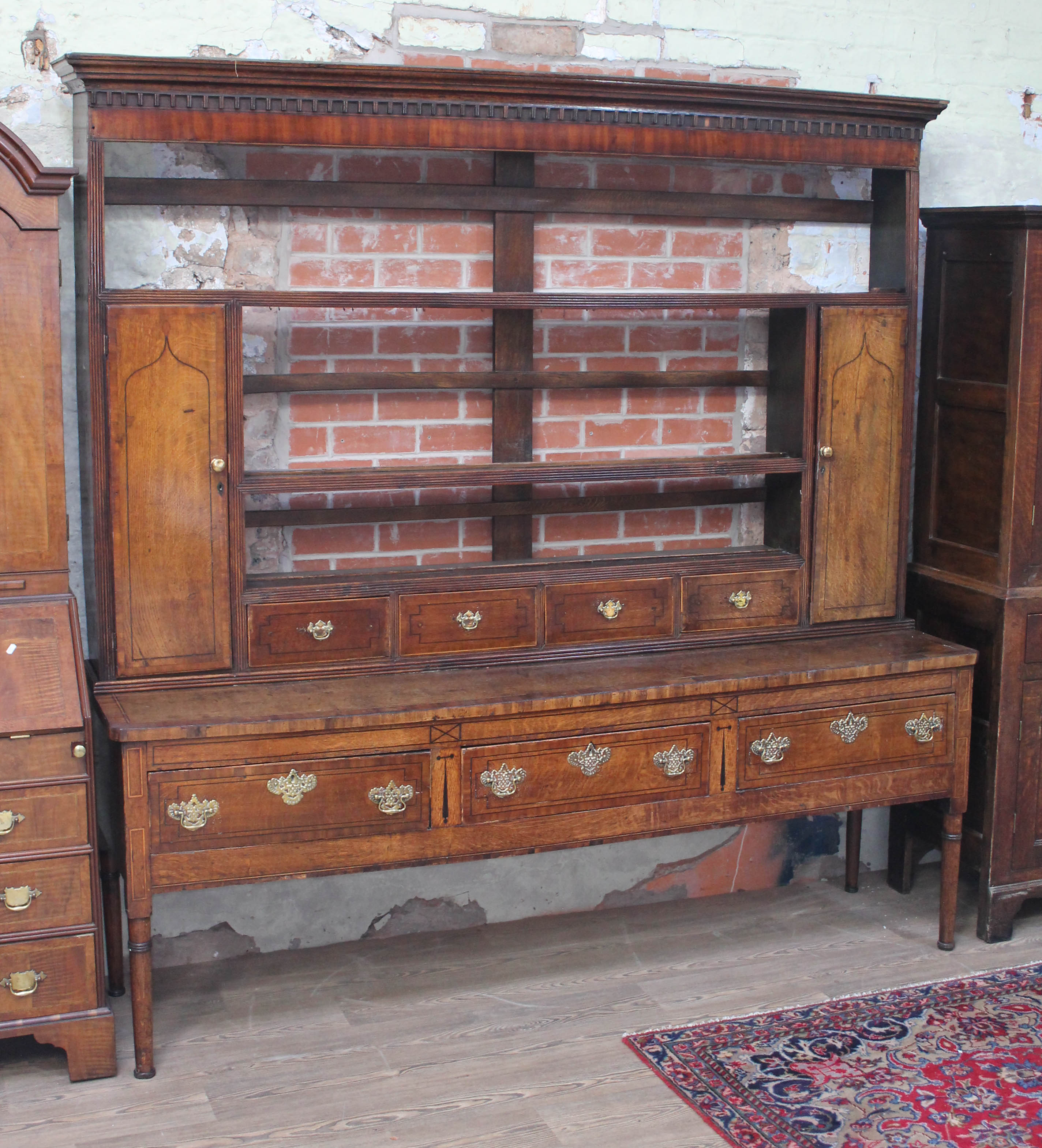 A Georgian inlaid oak and mahogany dresser, width 214cm, depth 52cm & height 216cm. Condition: