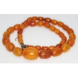 A single strand of butterscotch amber beads, the beads ranging from 7mm to 16mm, length 34cm,