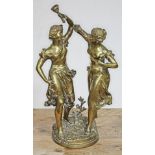 A bronze figure depicting two women dancing, one holding a torch, indistinctly signed, height