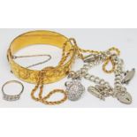 A mixed lot of jewellery comprising a rolled gold bangle, a hallmarked silver charm bracelet, a ring