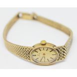 A ladies hallmarked 9ct gold Omega wristwatch and integrated 9ct gold strap, length 15cm, gross