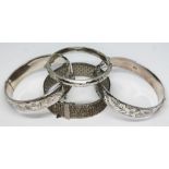 A group of four hallmarked silver bangles, diam. ranging from approx. 5cm - 6cm, wt. 106.87g.