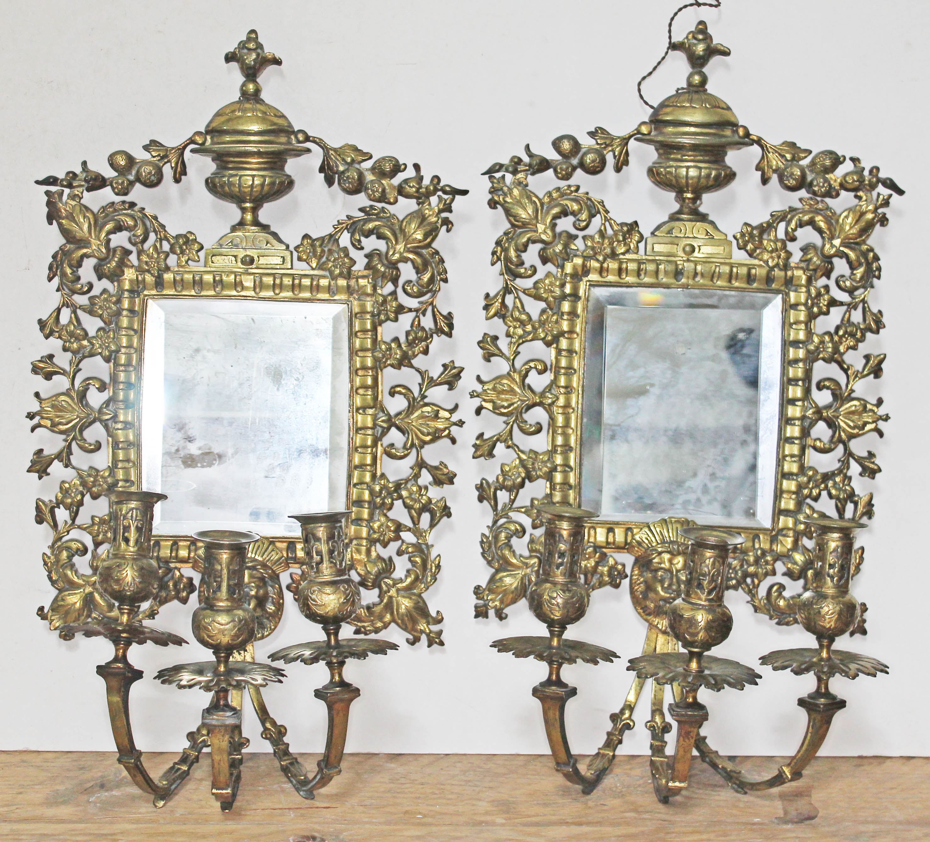 A pair of 19th century gilt bronze girandole mirrors and sconces, length 55cm, width 29cm.