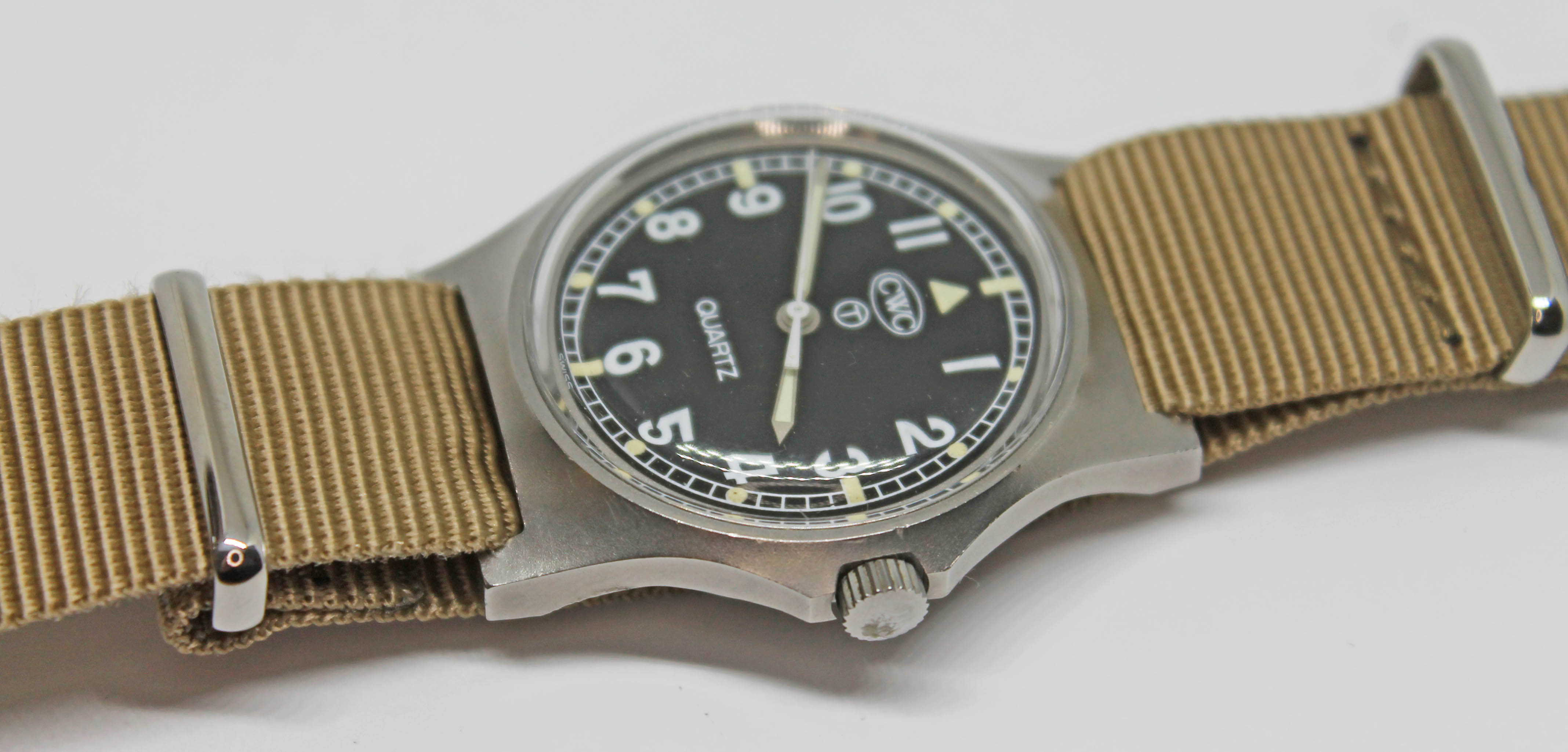 A 1980 CWC British military issue stainless steel quartz wristwatch, the signed black dial having