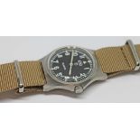 A 1980 CWC British military issue stainless steel quartz wristwatch, the signed black dial having
