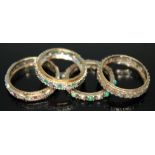 A group of four eternity rings comprising one hallmarked, another marked '375', one marked '9ct' and