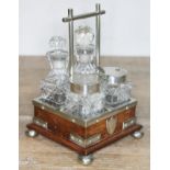 A silver plated and oak cruet in the manner of Christopher Dresser, height 16cm.