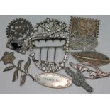 A mixed lot of mainly white metal and silver brooches together with a belt buckle.