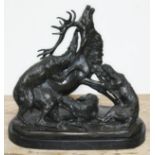 A bronze sculpture depicting three wolves attacking a stag, signed 'G Gardet', on marble base,