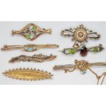 A group of seven brooches, four with various 9ct marks, gross wt. 7.07g, three others unmarked.