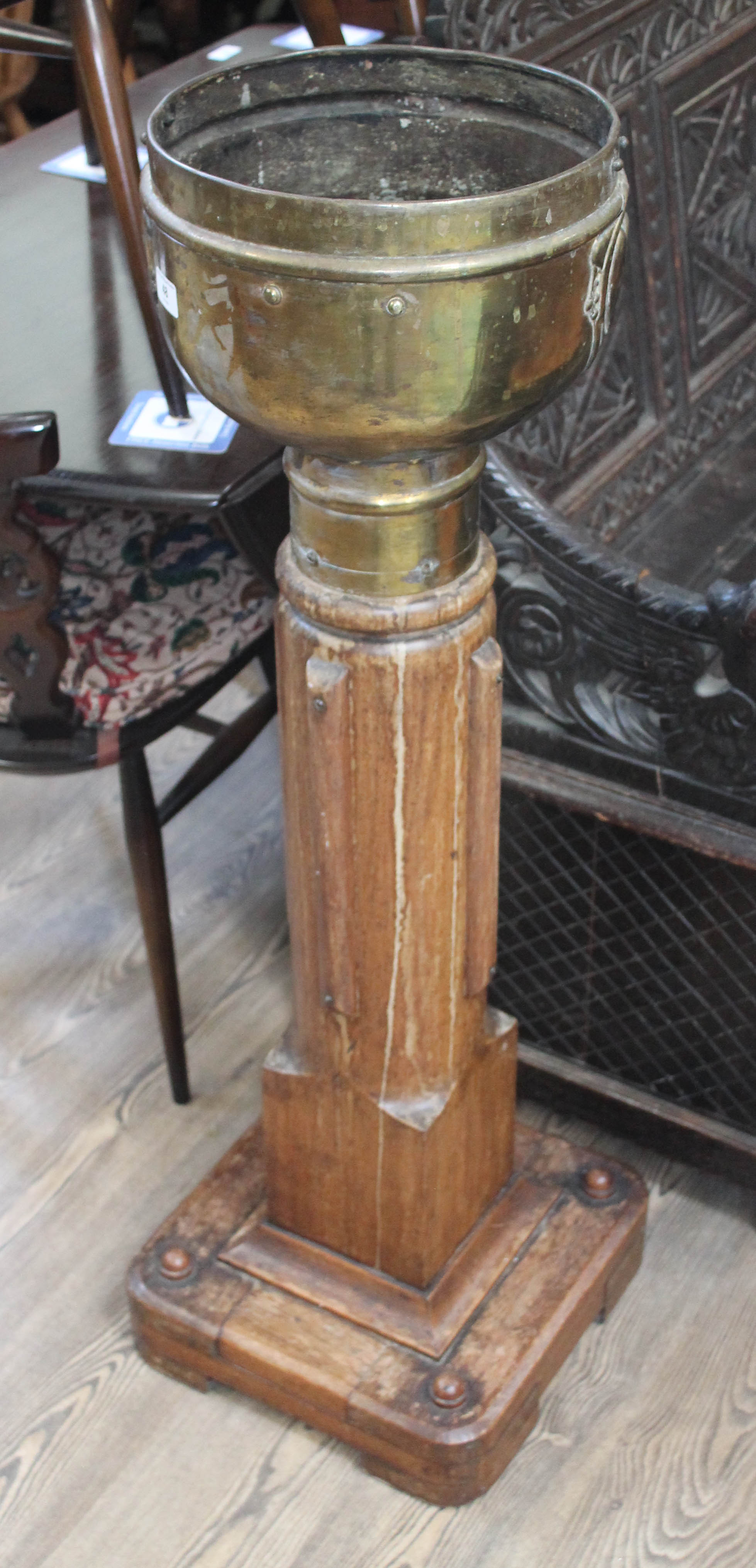 A late Victorian Art Nouveau style brass jardiniere on ecclesiastical base, the jardiniere stamped