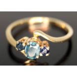 A three stone sapphire ring, band marked '750', gross wt. 1.83g. Condition - good, minor wear